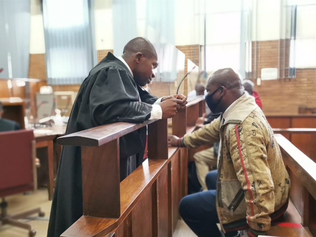Advocate Nqobizitha Mlilo consulting with one of the accused, Albert Gama.