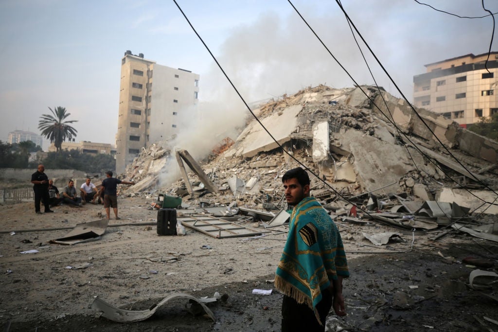 Palestinians gather next to the ruins of Watan Tow