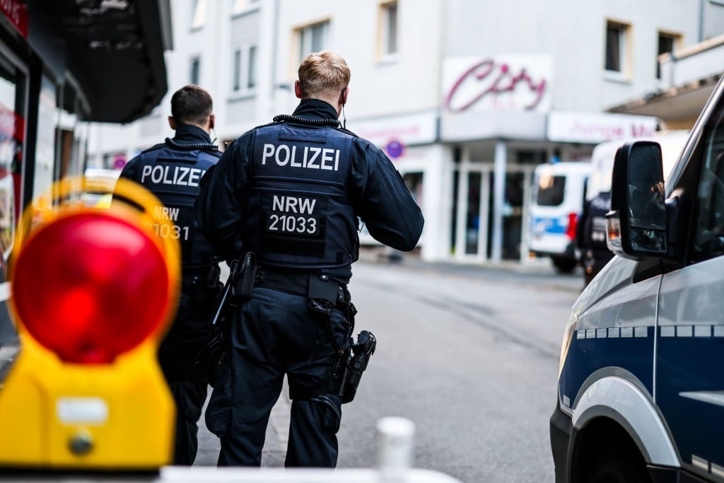 Police officers stand at a cordon in the city center in the early morning. Several people were killed and injured in an attack at the city's 650th anniversary celebrations.
