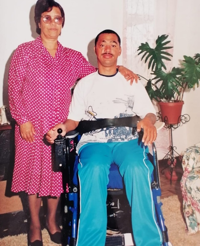 man in a wheelchair with his mother by his side 