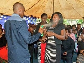 Prophet Lethebo Rabalago uses Doom on one of his congregants.