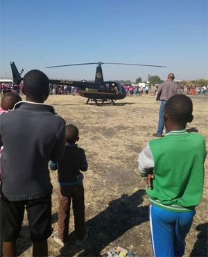 People watch as Vusi takes a look around inside the chopper.<br />