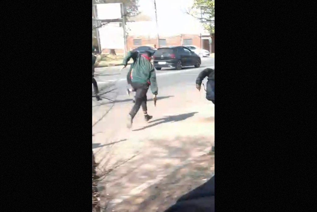 Screengrab from video of pupil chasing after another boy with a gun