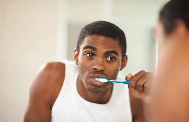 man brushing his teeth