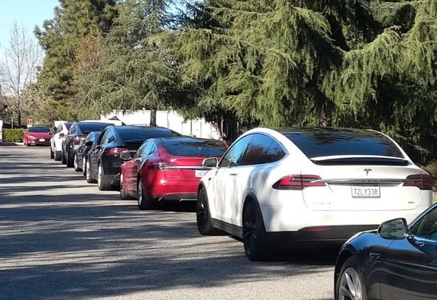 Unhappy Tesla owners wait in long line to have their electric cars