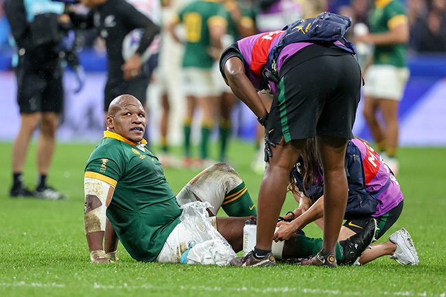 Springbok hooker Bongi Mbonambi receives attention after suffering a knee injury in the Rugby World Cup final against New Zealand at the Stade de France on 28 October 2023. (Photo by RvS.Media/Sylvie Failletaz/Getty Images)