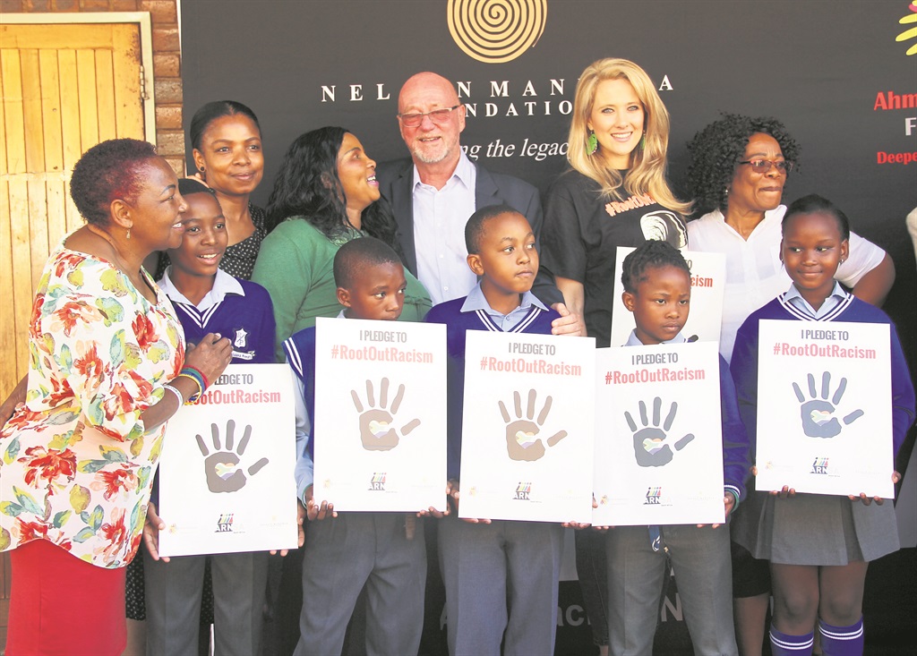 Back, third left: Minister of Tourism Derek Hanekom and environmentalist Catherine Constantinides with members of the Nelson Mandela and Ahmed Kathrada foundations. They were at an anti-racism event at Paul Mosaka Primary School in Pimville, Soweto.     Photo by Collen Mashaba