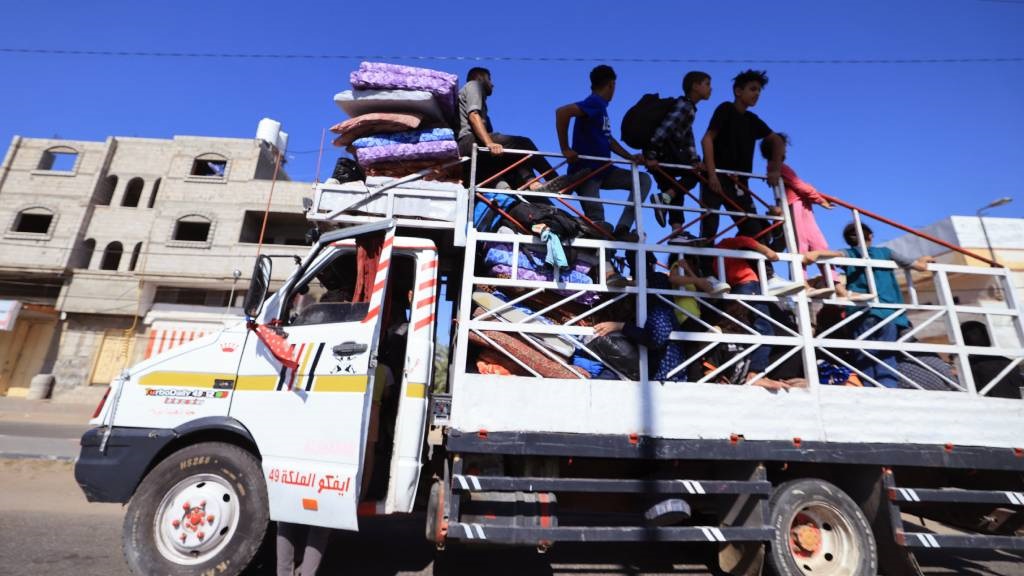 A truck transports a Palestinian family and their 