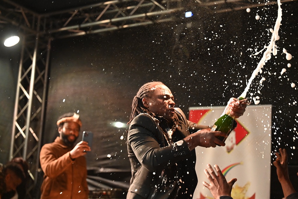 Inyanga Bhaka Nzama popping champagne during his birthday celebration. Photo by Jabulani Langa