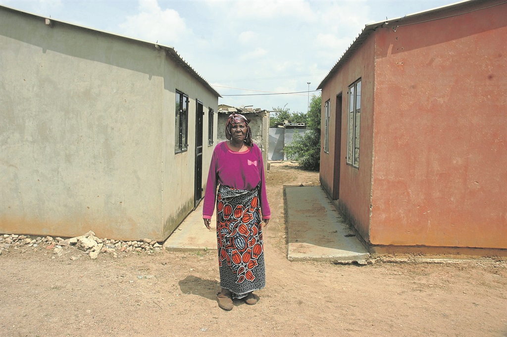 Ntombifuthi Malimela stands between the two houses built in her yard in Vosloorus.                       Photo by   Phineas Khoza