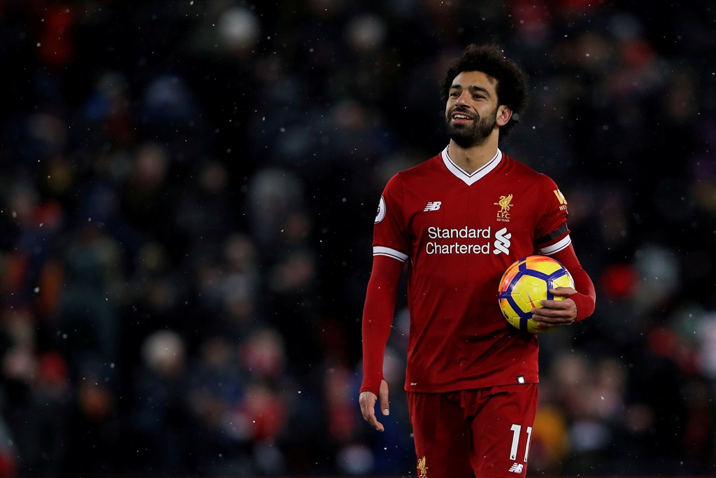  Taking the ball home: Liverpool's Mohamed Salah celebrates with the match ball after the match against Watford where he scored four goals. Picture: Lee Smith/Reuters
