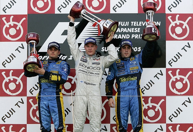 Kimi Raikkonen (middle) on the podium after winning the 2005 Japanese GP ahead of Renault drivers, Giancarlo Fisichella (left) and Fernando Alonso. Image: Paul Gilham/Getty Images