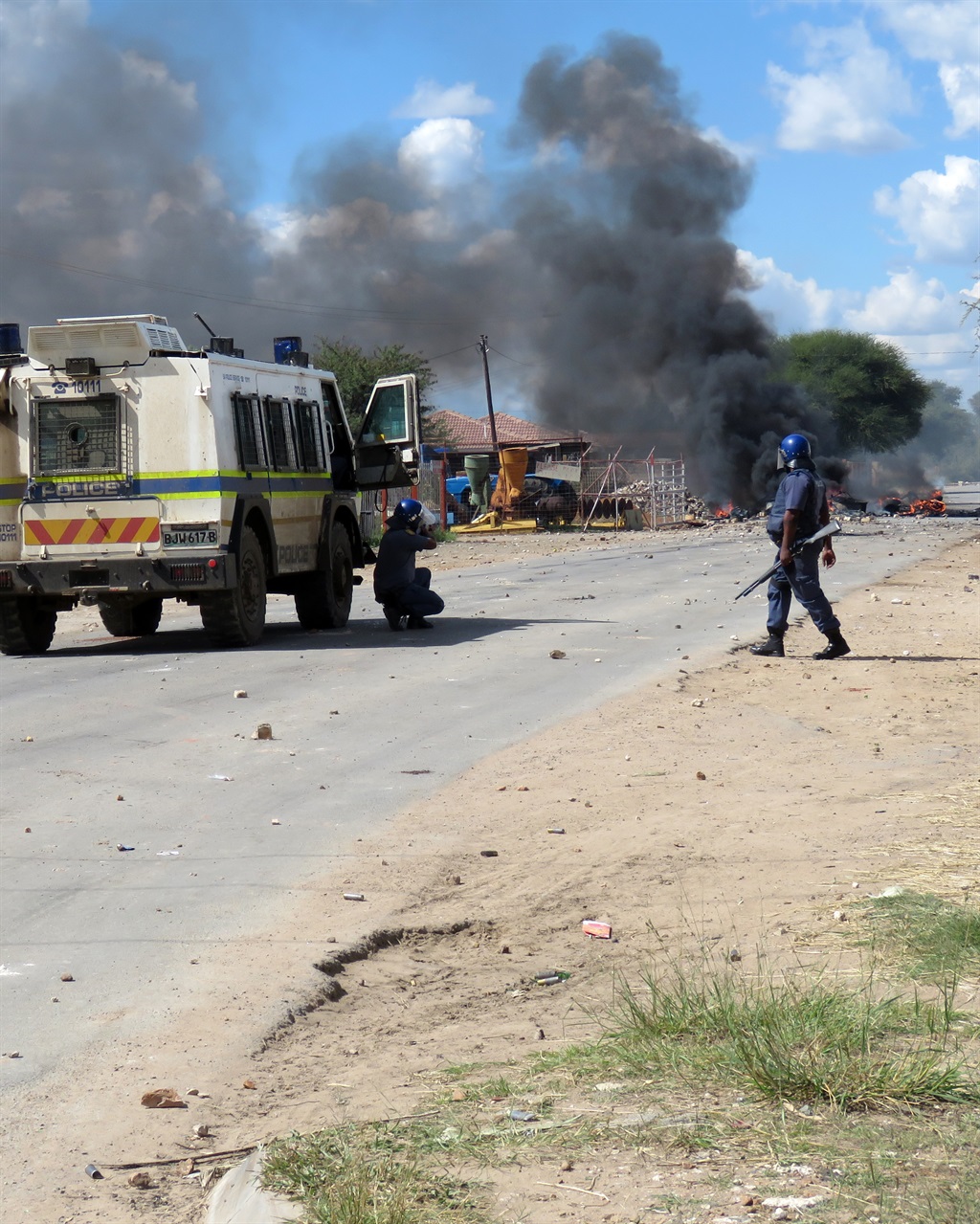 Running battles continued till late in the afternoon between police and anti-Supra Mahumapelo protesters in Lonely Park, Mahikeng. The violence spread as protesters used corrugated iron to defend themselves from rubber bullets.Picture: Dulile Sowaga