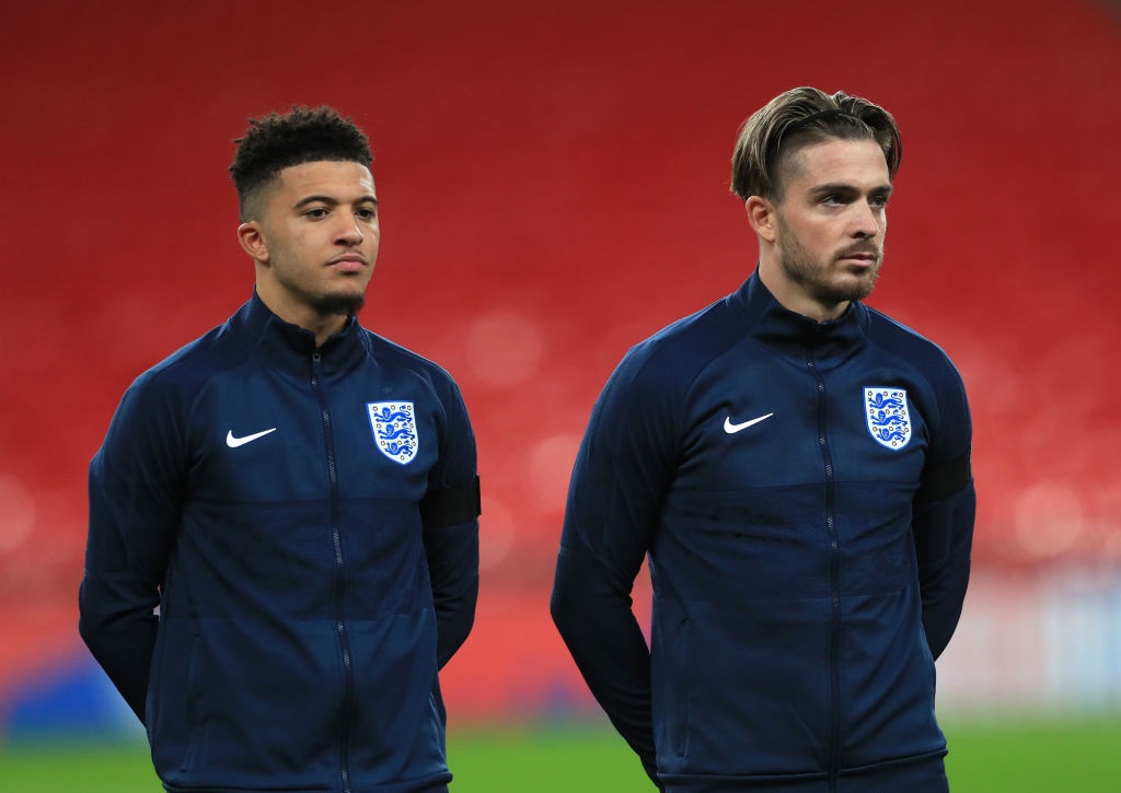 LONDON, ENGLAND - NOVEMBER 12: Jadon Sancho of England and Jack Grealish of England(R) look on during the national anthems during the international friendly match between England and the Republic of Ireland at Wembley Stadium on November 12, 2020 in London, England. Sporting stadiums around the UK remain under strict restrictions due to the Coronavirus Pandemic as Government social distancing laws prohibit fans inside venues resulting in games being played behind closed doors. (Photo by Mike Egerton - Pool/Getty Images)
