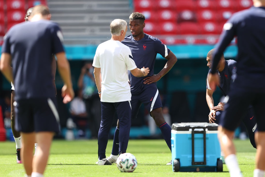 BUDAPEST, HUNGARY - JUNE 18: Didier Deschamps, Head Coach of France speaks with Paul Pogba of France during the France Training Session ahead of the UEFA Euro 2020 Championship Group F match between Hungary and France at Puskas Arena on June 18, 2021 in Budapest, Hungary. (Photo by Alex Pantling/Getty Images)