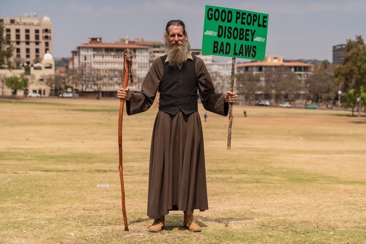 A protester at the Union Buildings on Saturday demonstrating against the slow pace of government reform in the cannabis industry. Photo: Ihsaan Haffejee