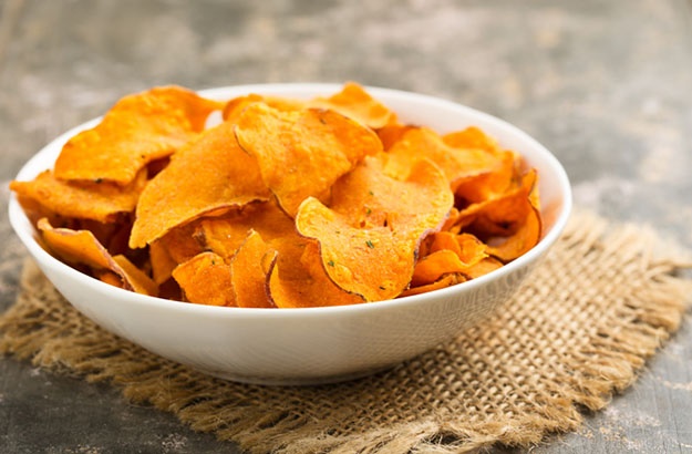 Hearty sweet potato crisps served in a bowl.