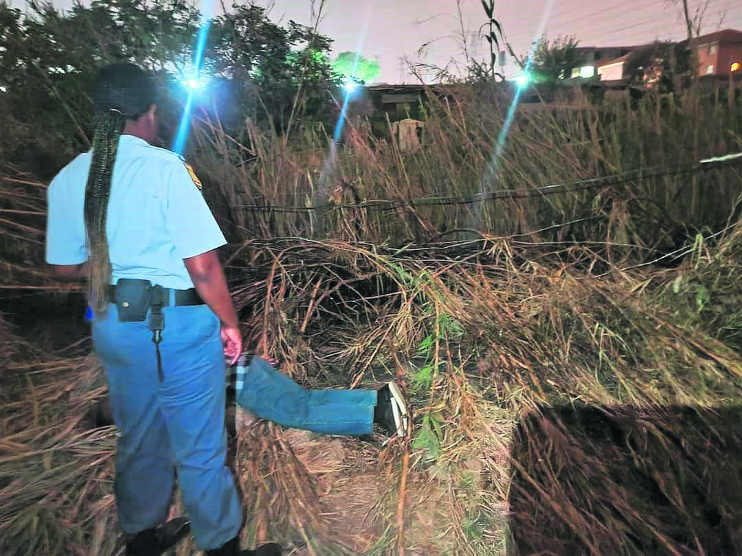 An officer at the scene of a deadly incident at Greenville squatter in Alexandra, east of Joburg, on Friday.