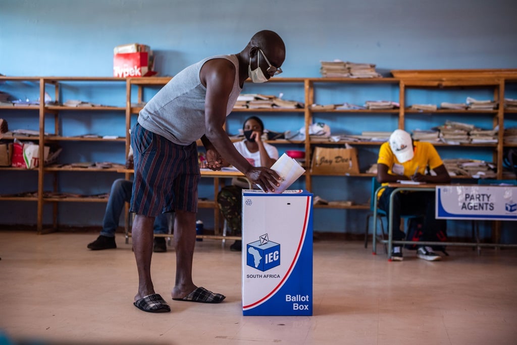 A voter casts their ballot. 