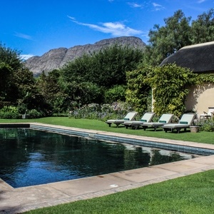 La Rive Villa lloking out on in Franschhoek mountains from its garden and swimming pool. (Photo: Gabi Zietsman)