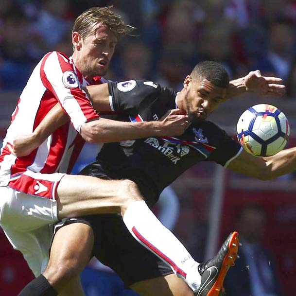 Stoke City's Peter Crouch, left, and Crystal Palace's Ruben Loftus-Cheek battle for the ball (AP)