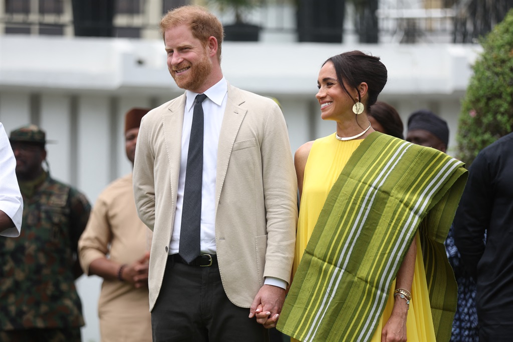 Britain's Prince Harry (2ndR), Duke of Sussex, and Meghan (R), Duchess of Sussex, react as Lagos State Governor, Babajide Sanwo-Olu (unseen), gives a speech at the State Governor House in Lagos on 12 May 2024 as they visit Nigeria as part of celebrations of Invictus Games anniversary. (Kola Sulaimon/AFP)