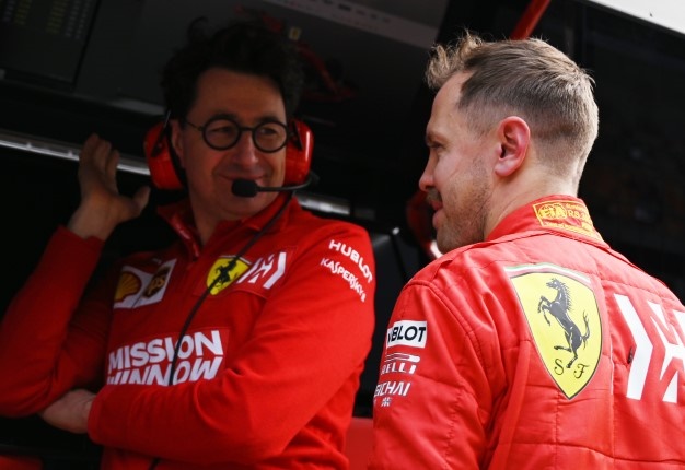 Sebastian Vettel chats with Ferrari team principal Mattia Binotto. Image: Greg Baker / AFP
