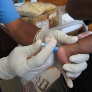 A healthcare worker testing a baby for HIV