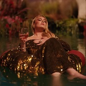 See Adele drinking wine on a floaty in a lazy river in new music video