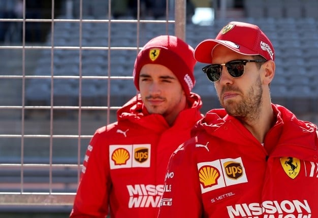 Charles Leclerc of Monaco and Ferrari and Sebastian Vettel of Germany and Ferrari look on, on the pit wall at Circuit of The Americas in Austin, Texas. Charles Coates/Getty Images/AFP