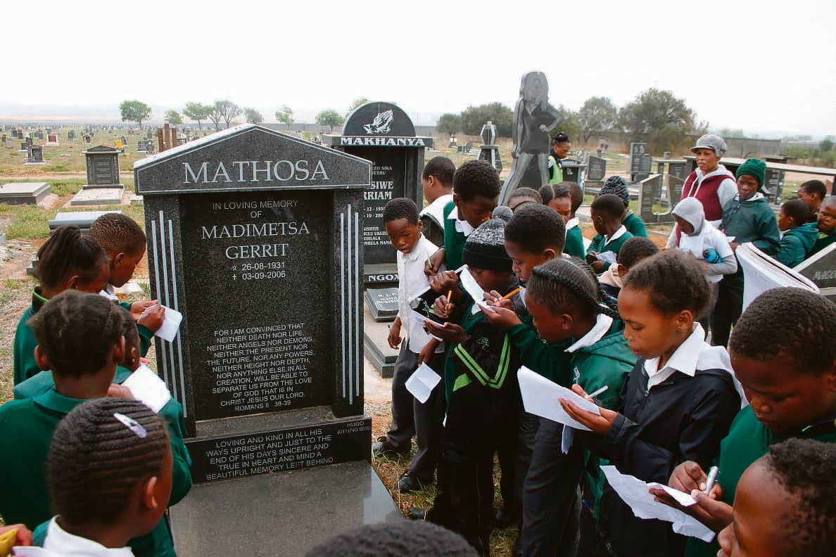 Kids from George Mbilase Primary School in Etwatwa getting lessons at the local graveyard.     Photo by Phineas Khoza