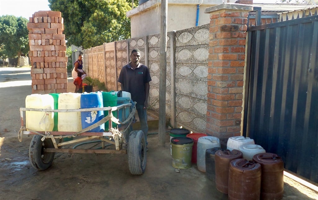 Man with makeshift cart to transport water