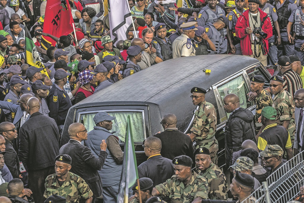 Mama is home: Mourners and members of the MK veterans surround the hearse which brought the body of Mama Winnie Madikizela-Mandela to her home in Orlando on Friday before her burial yesterday. Thousands of people gathered along the streets of Orlando to form a guard of honour as her body was brought home. Picture: Charlie Shoemaker / Getty Images