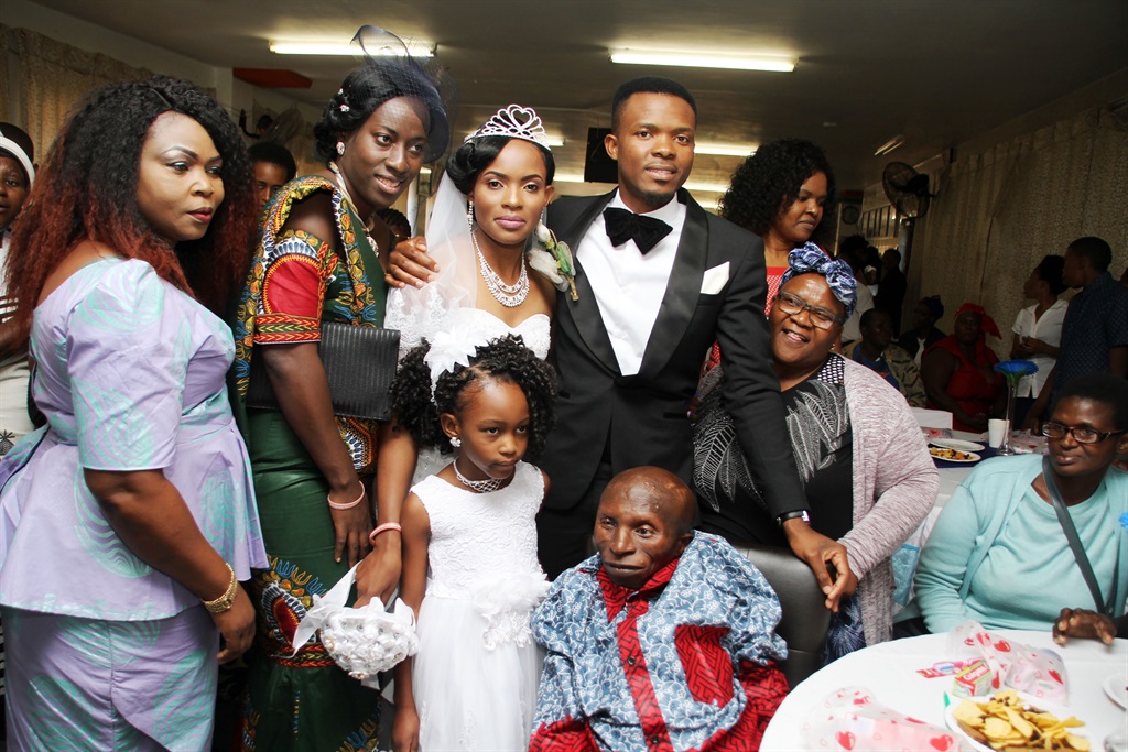 Beautiful inside and out: Couple Falone Zeka and Kevine Mbuyi Zeka takes pictures with guests and Vukuhambe Disabled Centre leader Thozi Mciki (sitting). Photo by Lindile Mbontsi