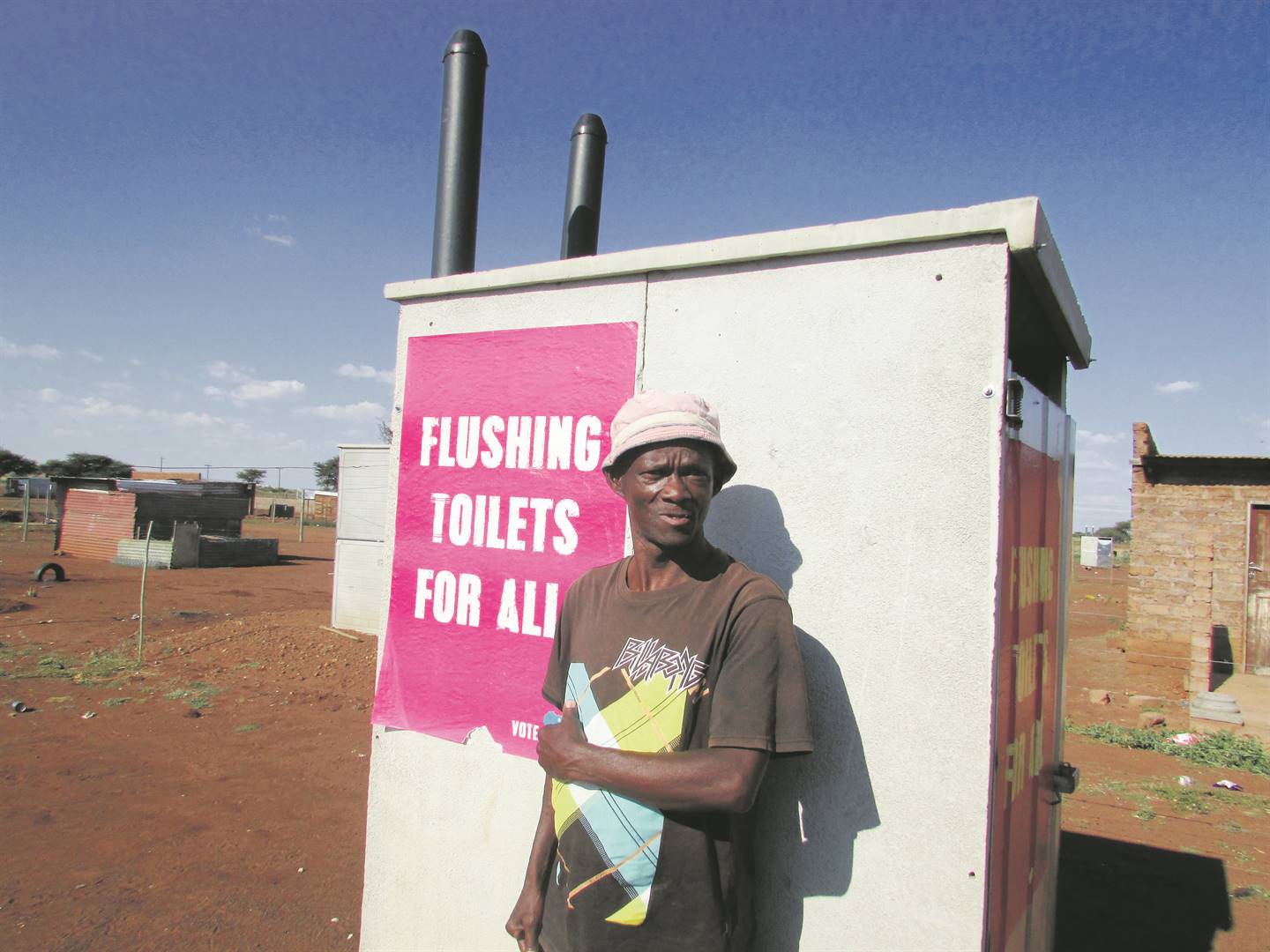 Vader Motlhabedi stands next to his pit toilet. Picture: Poloko Tau