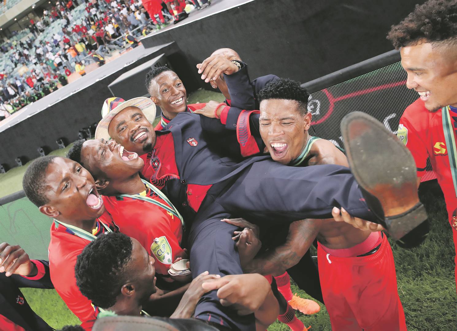 TS Galaxy players lift club boss Tim Sukazi as they celebrate their historic win over Kaizer Chiefs in the Nedbank Cup final in Durban last weekend. Picture: Muzi Ntombela /BackpagePix