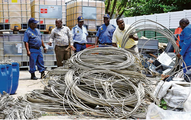 Police look on at the nearly two tons of stolen aluminium cables recovered at a Hermanus scrapyard west of 
Pretoria. Photo by IOL 
