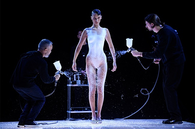 US model Bella Hadid is dressed by spraying Fabrican Spray-on fabric during the Coperni Spring-Summer 2023 fashion show as part of the Paris Womenswear Fashion Week, in Paris, on 30 September 2022.