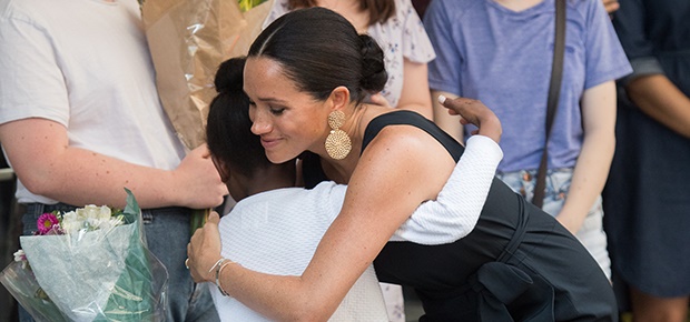Duchess Meghan hugs an adoring fan in Cape Town. (Photo: Getty Images)