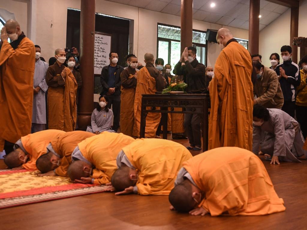 Buddhist monks pray during the funeral ceremony of Vietnamese monk Thich Nhat Hanh, 95, at the Tu Hieu Pagoda in Hue.