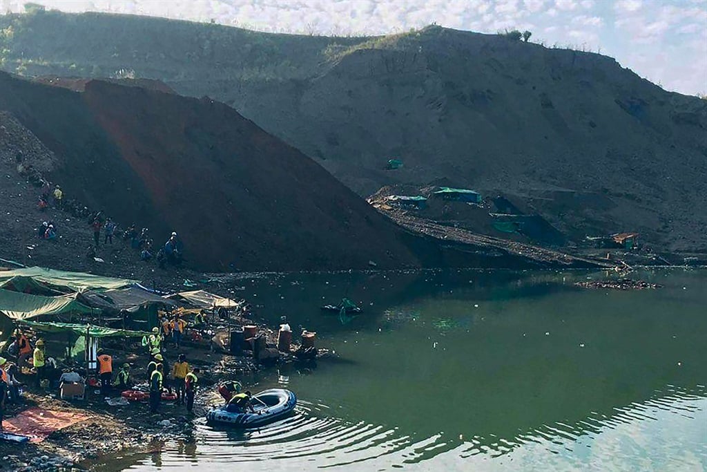 This photo taken and received via an anonymous source on December 22, 2021 shows rescue officials preparing to search for missing people after a landslide at a jade mine in Hpakant, Kachin state.
