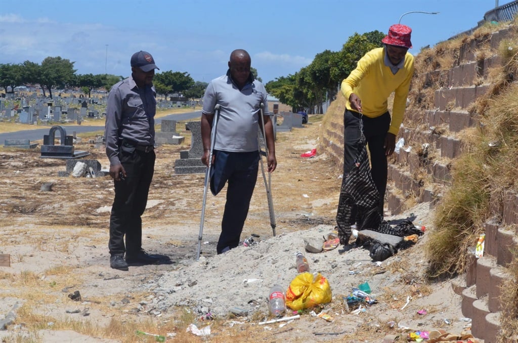 Left: Patroller Ntando Mayekiso, Sanco secretary Lumkile Msila and another Sanco leader Mluleki Andries at the graveyard. Photo by Lulekwa Mbadamane