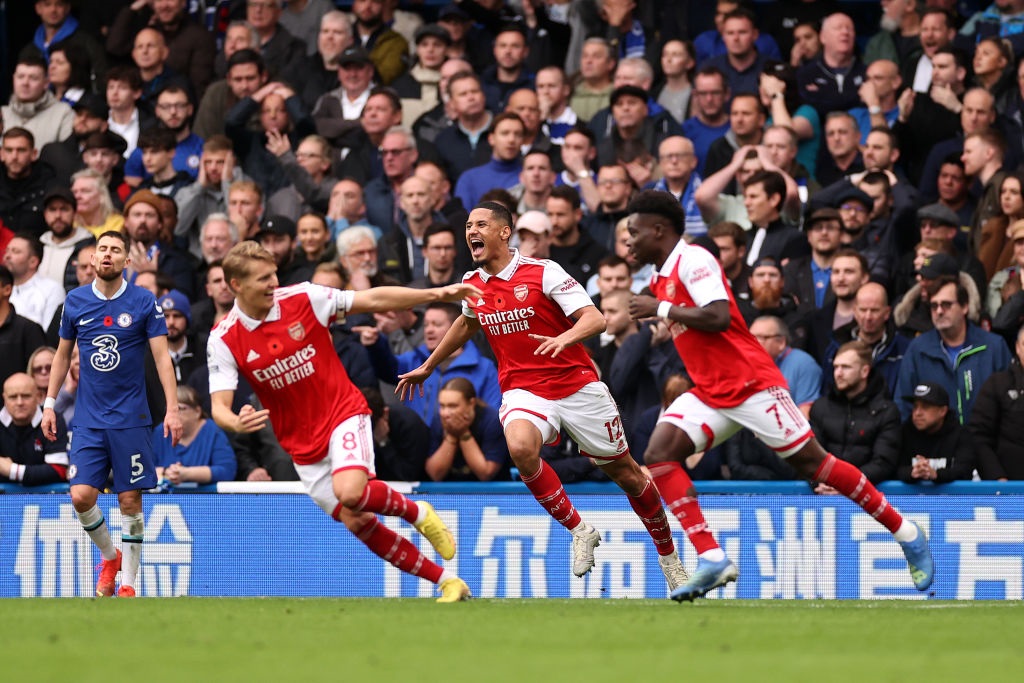LONDON, ENGLAND - NOVEMBER 06: William Saliba celebrates with Martin Oedegaard and Bukayo Saka after Gabriel of Arsenal (not pictured) scored their sides first goal during the Premier League match between Chelsea FC and Arsenal FC at Stamford Bridge on November 06, 2022 in London, England. (Photo by Ryan Pierse/Getty Images)
