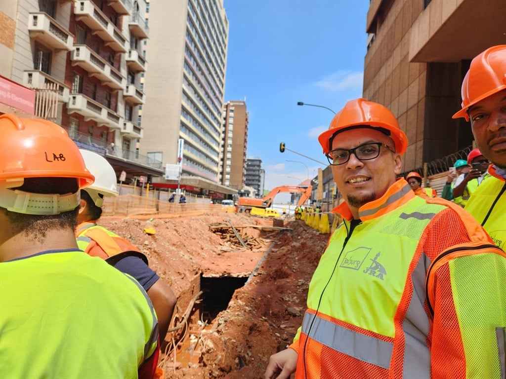 Johannesburg City manager Floyd Brink stands in front of an excavated utility passage under Lilian Ngoyi Street.