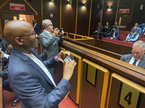 <p>Jacob Zuma Foundation spokesperson Mzwanele Manyi and Carl Niehaus taking pictures of Advocate Billy&nbsp;Downer and journalist Karyn Maughan in the dock of the Pietermaritzburg High Court.</p><p><em>- Adriaan Basson</em></p>