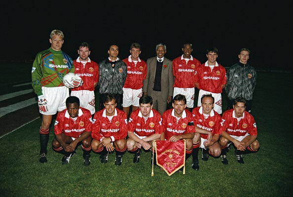 Manchester United squad posing with Nelson Mandela in Johennesburg, 1993.