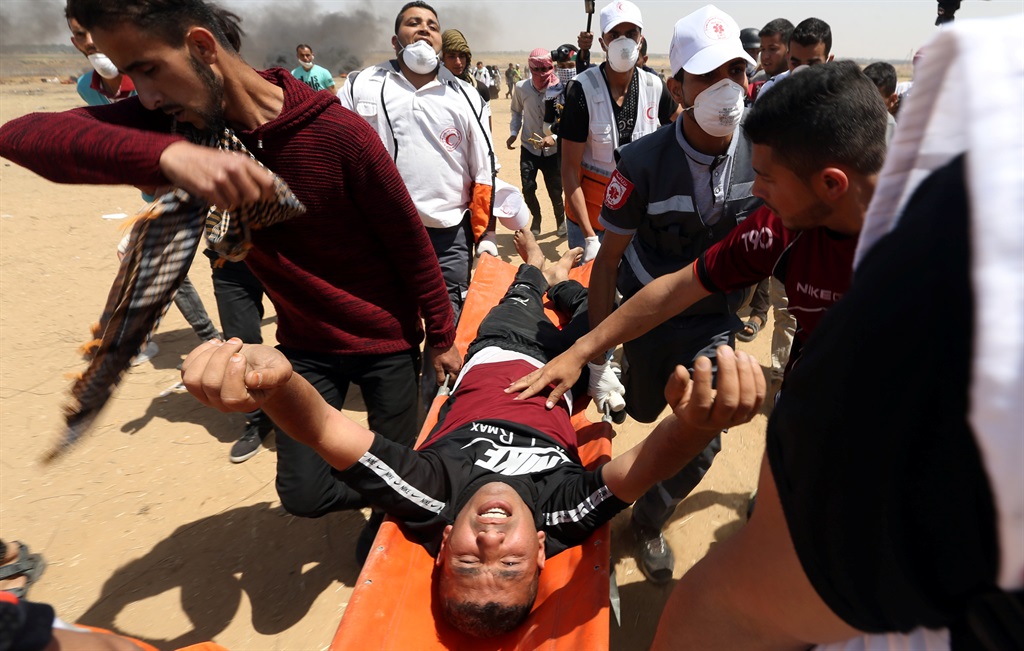 A wounded Palestinian is evacuated during a protest on Friday (May 11 2018) at the Israel-Gaza border in the southern Gaza Strip. Palestinians were demanding the right to return to their homeland. Picture: Ibraheem Abu Mustafa/Reuters