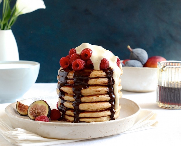 stacked pancakes with fresh berries and ice-cream