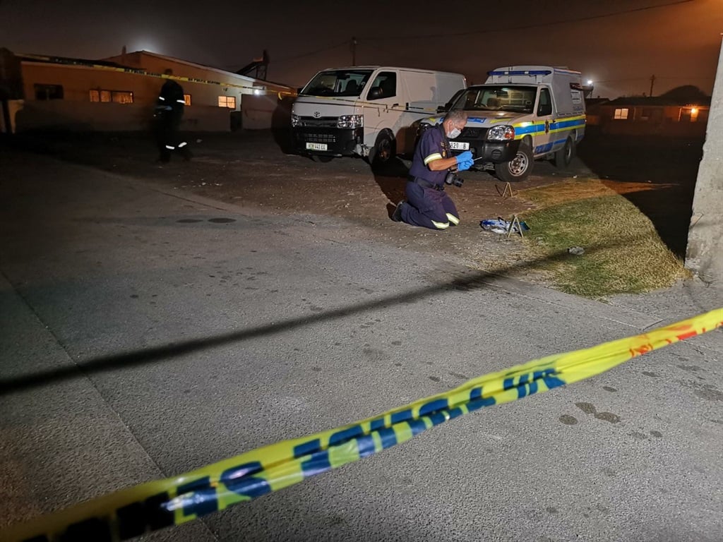 SAPS Forensic teams combing the scene where two used cartridges were found after the night shootingPHOTO: Nosipiwo Manona