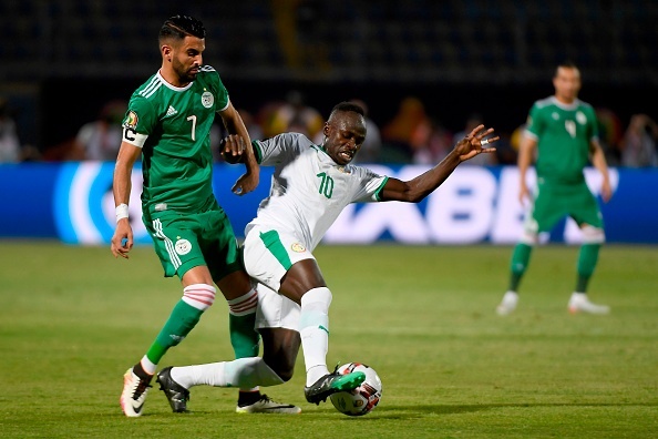 Algerias forward Riyad Mahrez (L) fights for the ball with Senegal forward Sadio Mane  